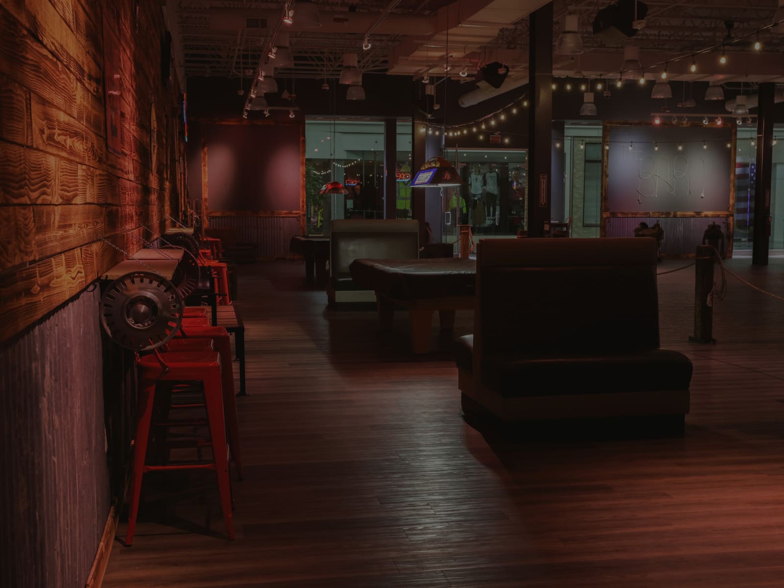 Booth seating and pool tables inside the venue