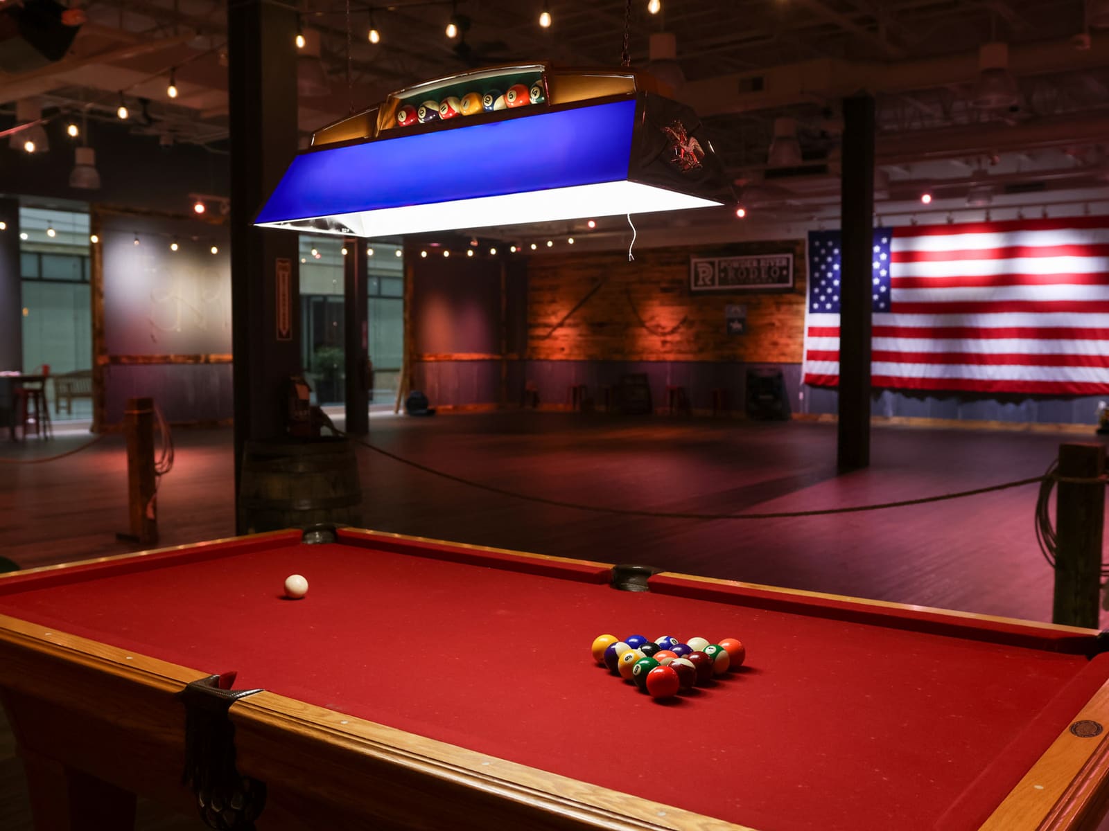 Pool table with American flag backdrop on the dance floor