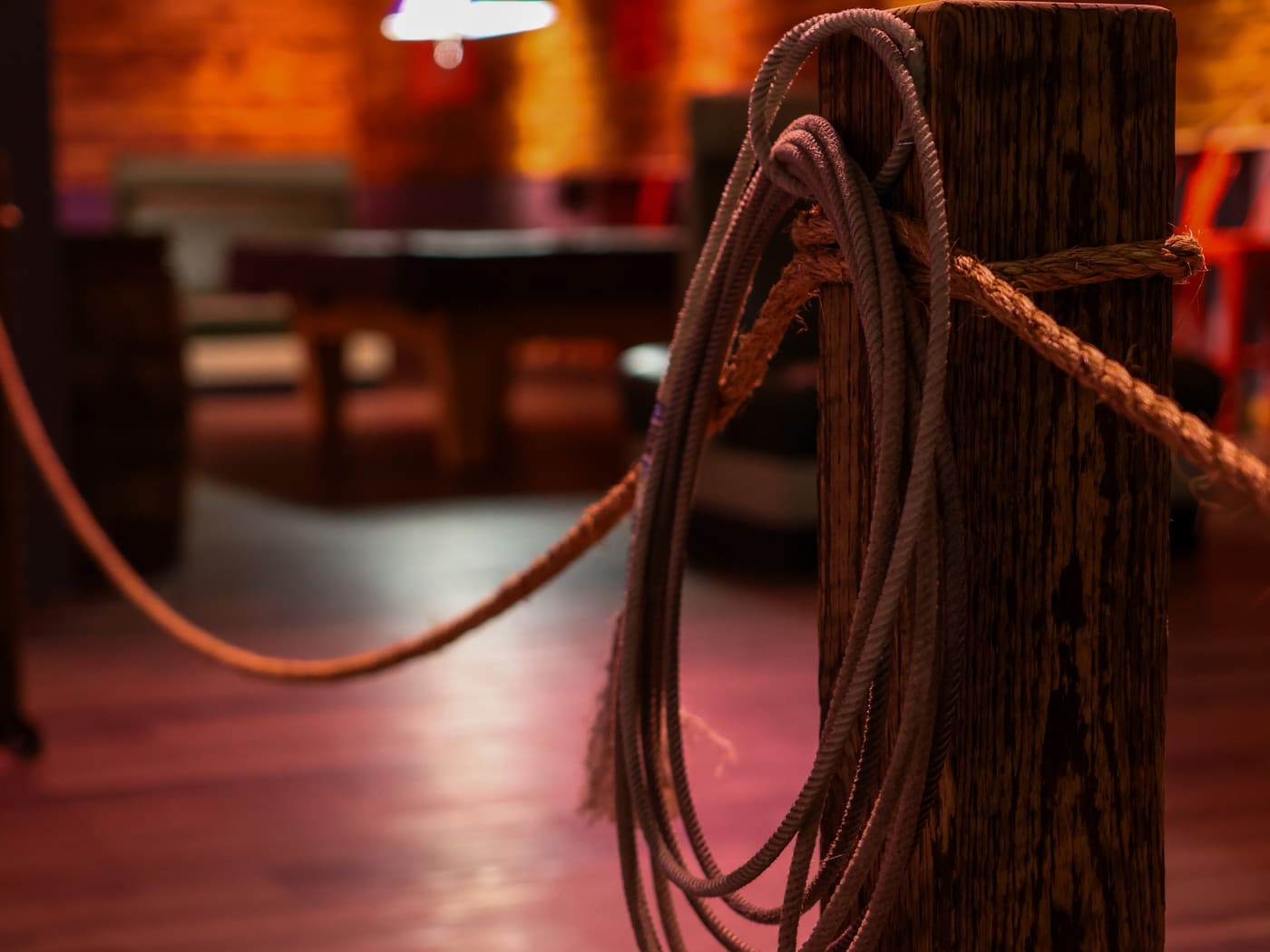 Western lasso rope tied to a wood post